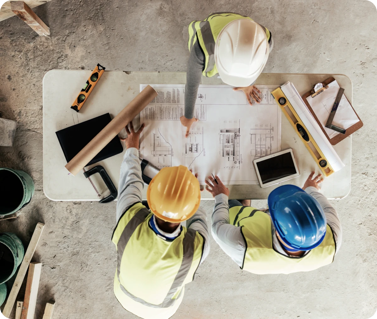 Team reviewing architectural plans on site